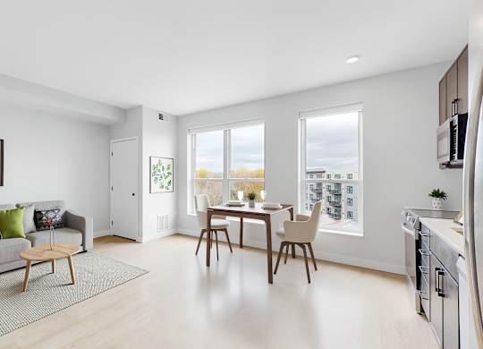 A modern living room with a grey couch and a wooden coffee table.