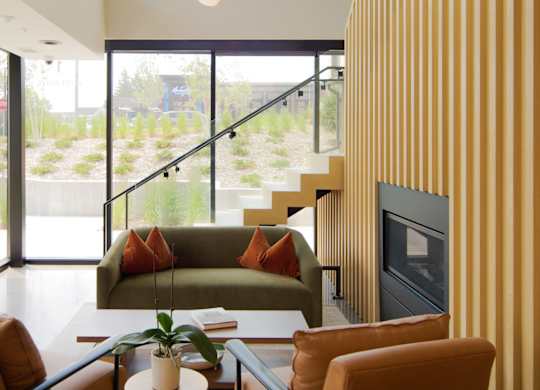 A living room with a couch, chairs, and a fireplace.