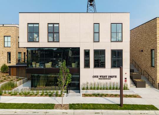 A modern building with the words "One West Drive" on the side.