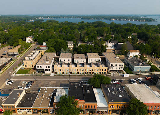 A view of a parking lot and buildings from an aerial perspective.