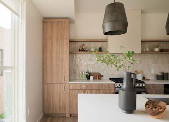A kitchen with a white counter and wooden cabinets.