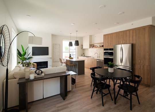 A modern kitchen with a dining table and chairs.