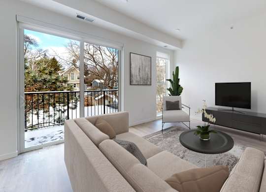 A living room with a couch, a chair, a coffee table, and a television.