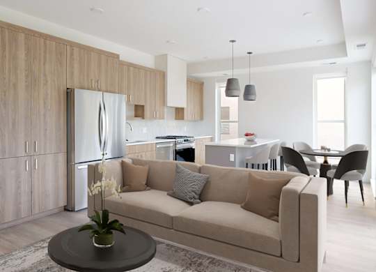 A modern living room with a beige sofa and a wooden cabinet.