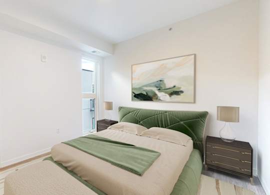 A bedroom with a bed, a nightstand, and a painting on the wall.