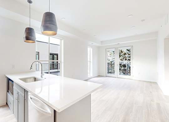 A modern kitchen with a white countertop at One West Drive Apartments, Minnesota, 55331