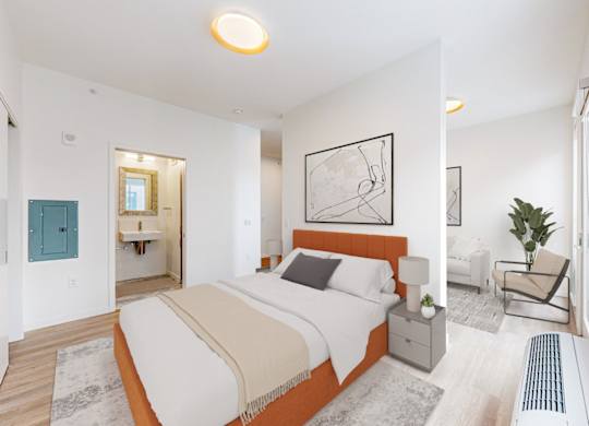 A bedroom with a large bed and a painting on the wall.