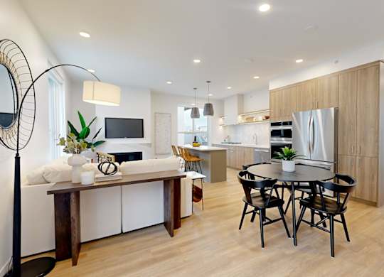 A modern kitchen with a dining table and chairs.