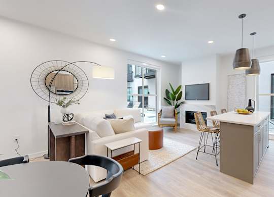 A modern living room with a grey table and a white sofa.