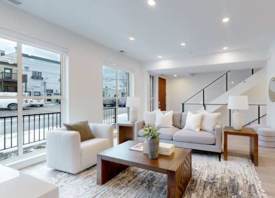 A living room with a couch, armchair, and coffee table.