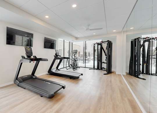 A gym with treadmills and other exercise equipment.