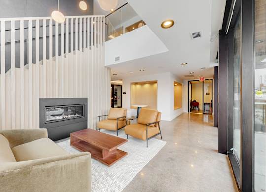 A modern living room with a fireplace and a glass door.