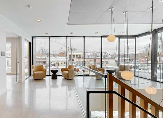A spacious interior with a glass railing and a view of the outdoors.