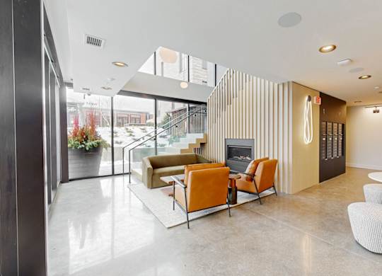 A modern living room with a fireplace and a glass door.