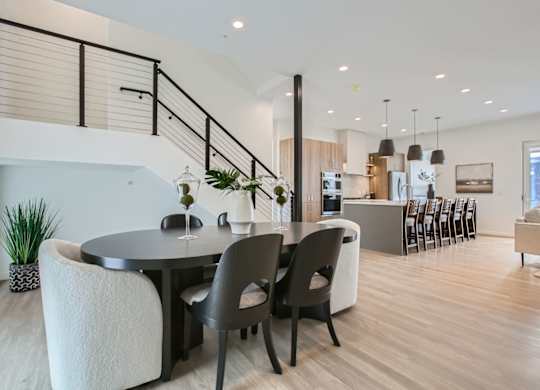 a dining room with a table and chairs at One West Drive Apartments, Excelsior, MN