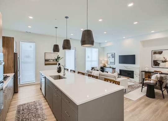 an open kitchen and living room with a white counter top at One West Drive Apartments, Minnesota