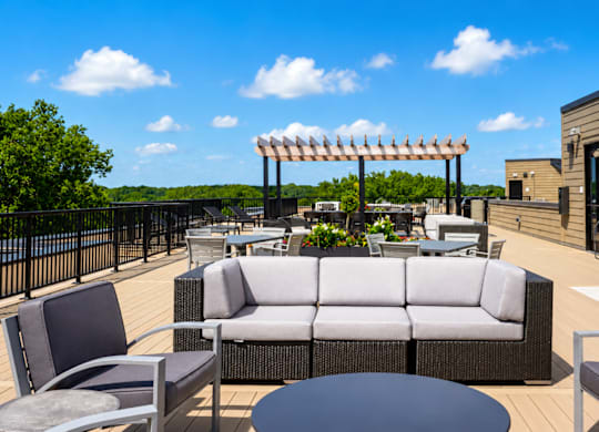 A patio with a table and chairs and a pergola.