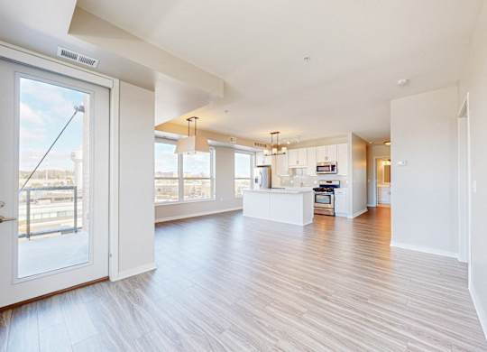 A spacious living room with a view of the city through the large windows.