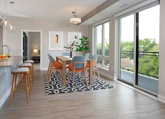 A dining room with a table set for six.