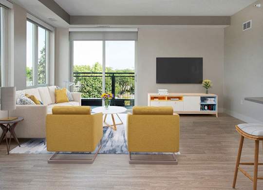 A living room with a white couch, yellow chairs, and a flat screen TV.