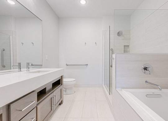 A white bathroom with a walk in shower.