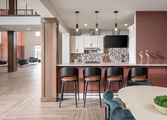 A modern kitchen with a bar area and seating.at The Edison at Maple Grove, Maple Grove, MN 55311