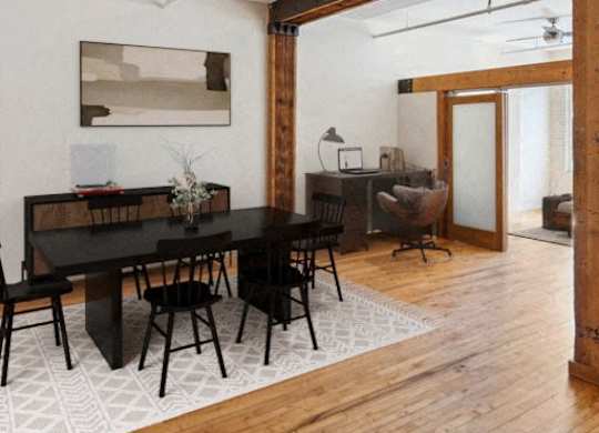 A dining room with a black table and chairs.at Lee Lofts, Minnesota