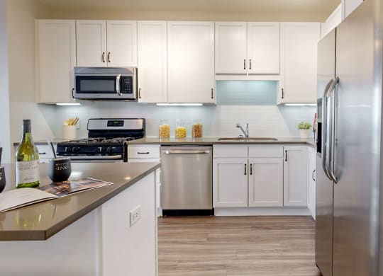 a kitchen with stainless steel appliances and white cabinets