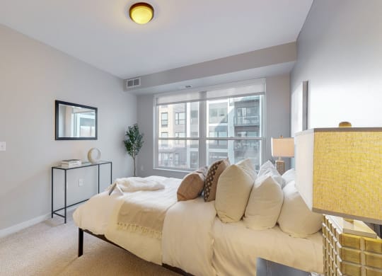 a bedroom with a large bed and a large window