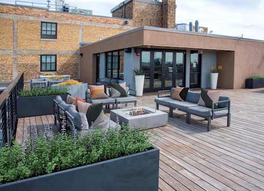A patio with a table and chairs is surrounded by a brick wall.