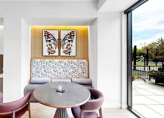 A modern dining area with a round table and chairs.