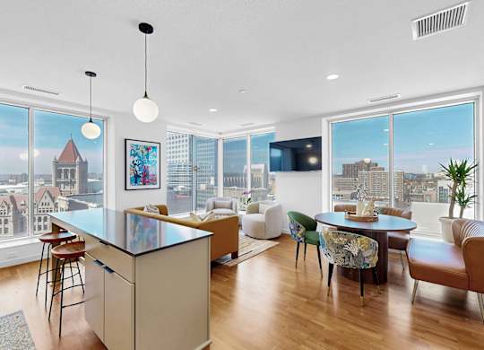 A modern kitchen with a large island and a view of the city.