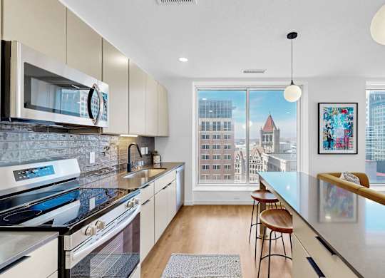 A modern kitchen with a view of the city.