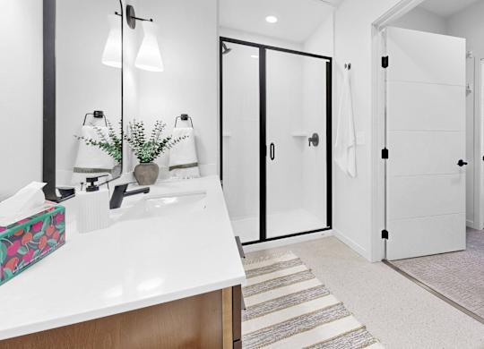 A bathroom with a white sink and a mirror above it.