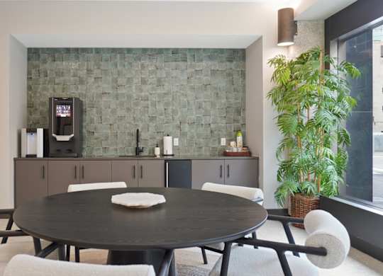 A modern dining room with a round table and chairs.