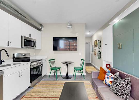A kitchen with a table and chairs in the middle of it.