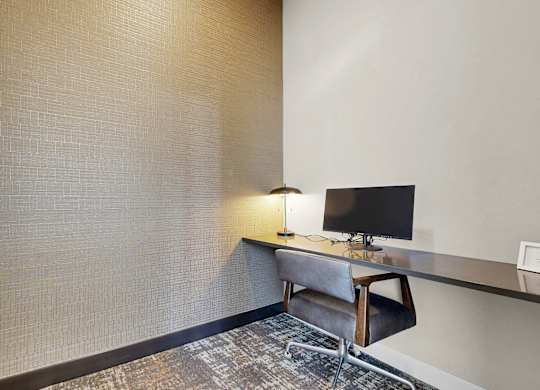 A room with a desk and a chair.