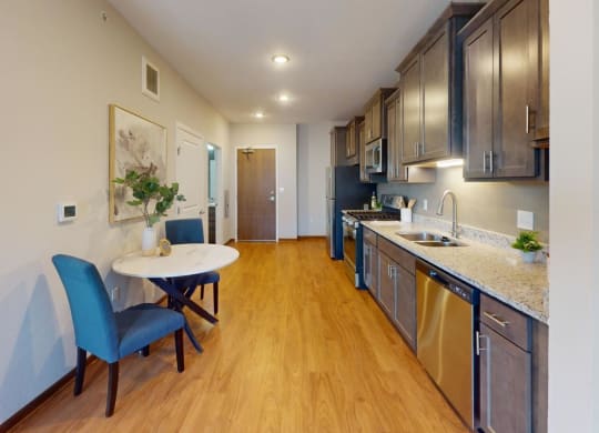 a kitchen and dining room with a table and chairs