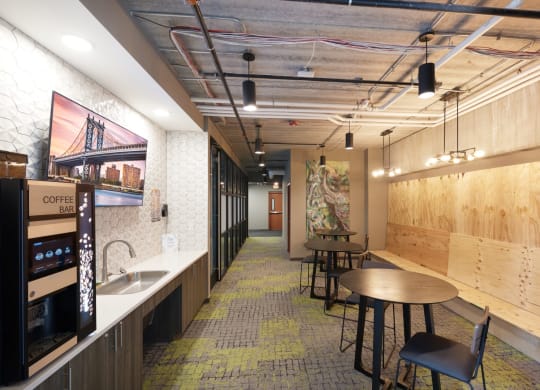 a room with tables and chairs and a wall of windows