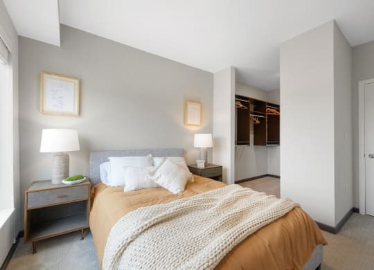 a bedroom with a large bed and a closet
