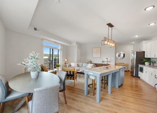 a living room and dining room with a blue table and chairs
