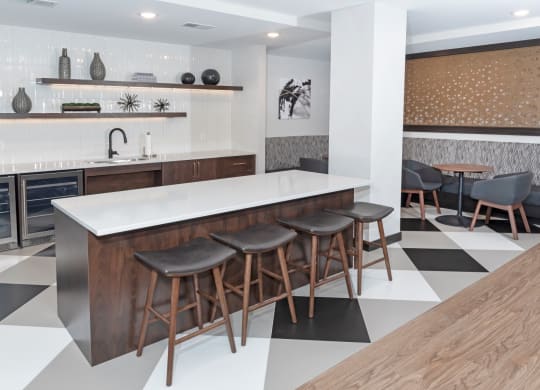 a kitchen with a white counter top and black and white tiles on the floor at The Exchange Apartments, New Brighton