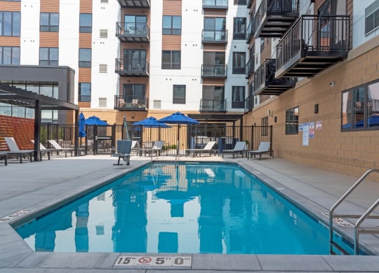 Pool With Relaxing Chairs at The Exchange Apartments, New Brighton, MN