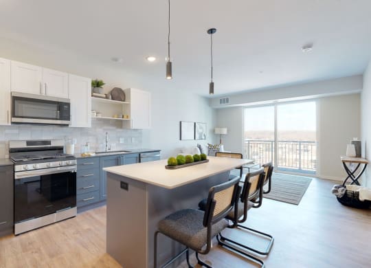 a kitchen and living room with a large window and a balcony at The Exchange Apartments, Minnesota