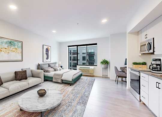 A modern living room with a grey sofa and a coffee table.