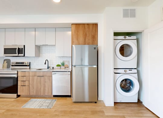 a kitchen with a washing machine and a refrigerator at The Mason, St. Paul, 55114