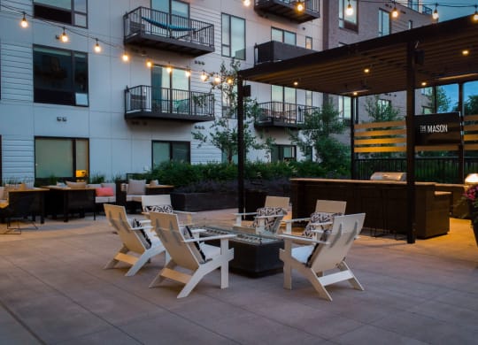 a patio with tables and chairs outside of a building at The Mason, St. Paul, Minnesota