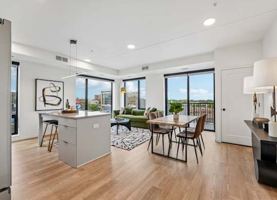 A modern kitchen with a dining table and chairs.