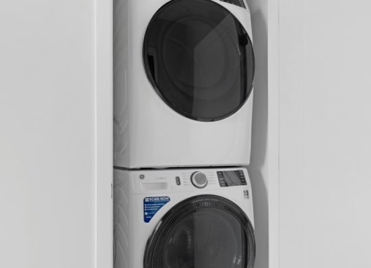 a white washer and dryer in a small laundry room