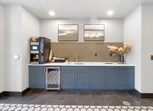 a kitchen with blue cabinets and a coffee machine
